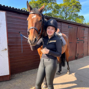 Young Volunteer of the Year, Cara stands with bay horse Ferno.