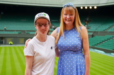 RDA participant Philippa George stands with Park Lane Stables RDA Group Chair Natalie O'Rourke against the backdrop of Wimbledon Centre Court.