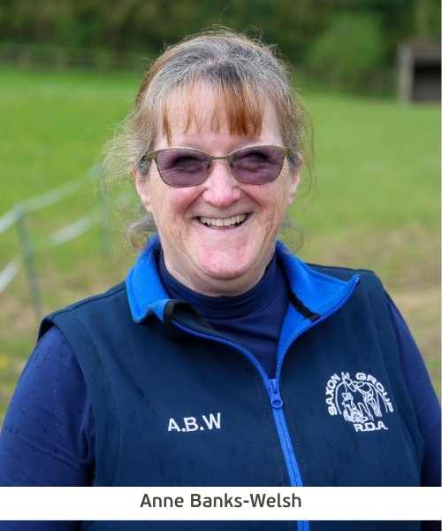 A headshot photo of Anne Banks-Welsh from Saxon RDA. She is wearing navy blue shirt and gilet.