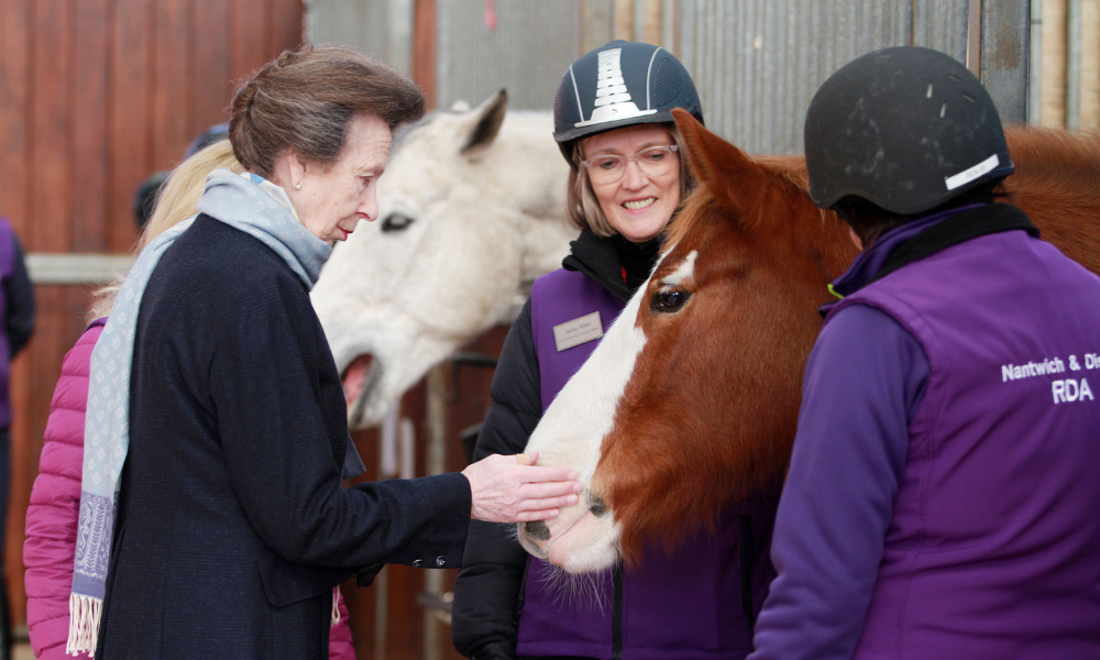 The Princess Royal meets pony Bernard and volunteers. Bernard is a large chestnut coloured horse.