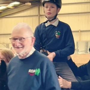 Ben Wishart, Participant of the Year, riding at Ballyclare RDA, being led by volunteers.