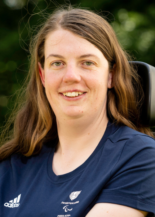 Mari Durward-Akhurst smiles proudly. She is wearing an official Paralympics tshirt.