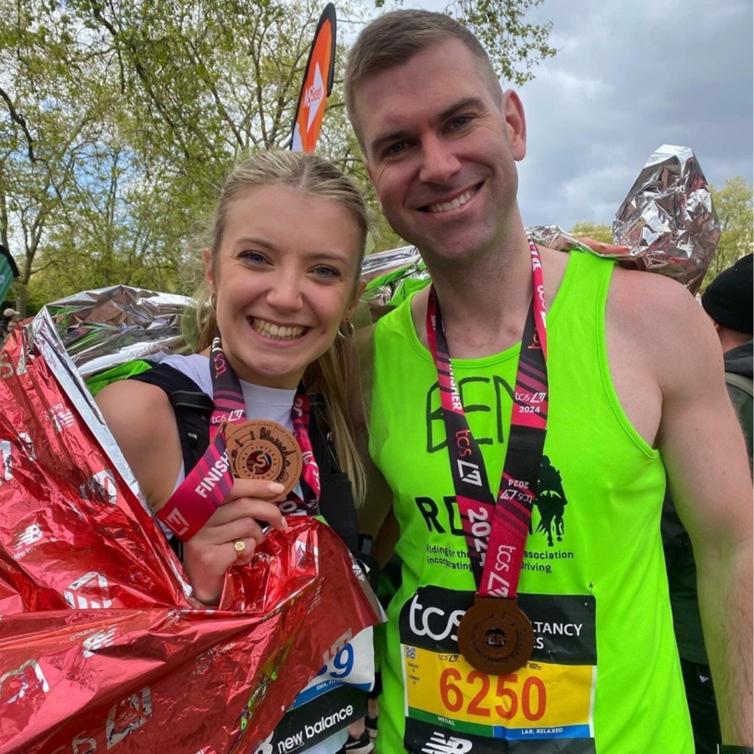 Image of two participants of the London Marathon with medals