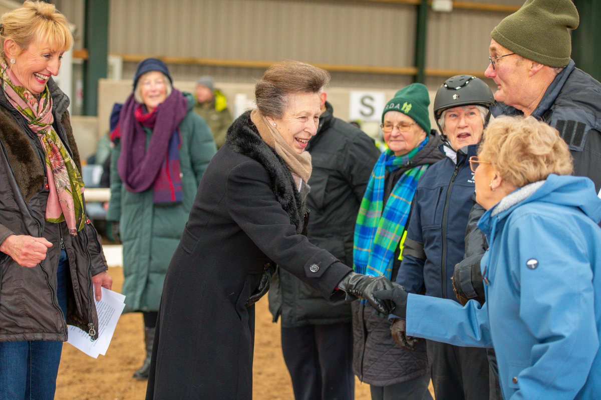 HRH shaking hands with a volunteer