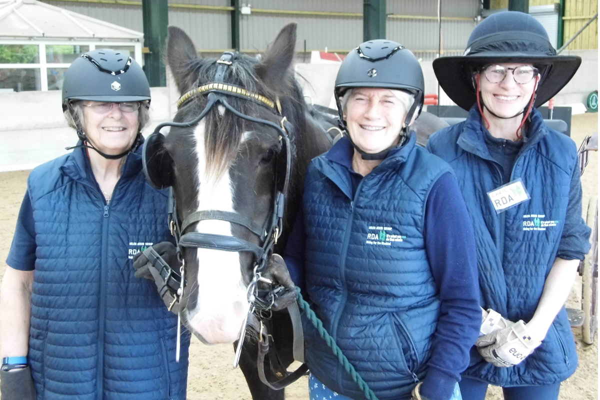 image of RDA volunteers and participant with a carriage driving horse