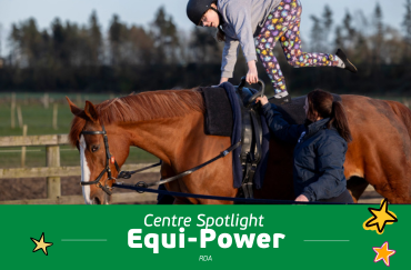 participant vaulting on a chestnut horse with coach supporting