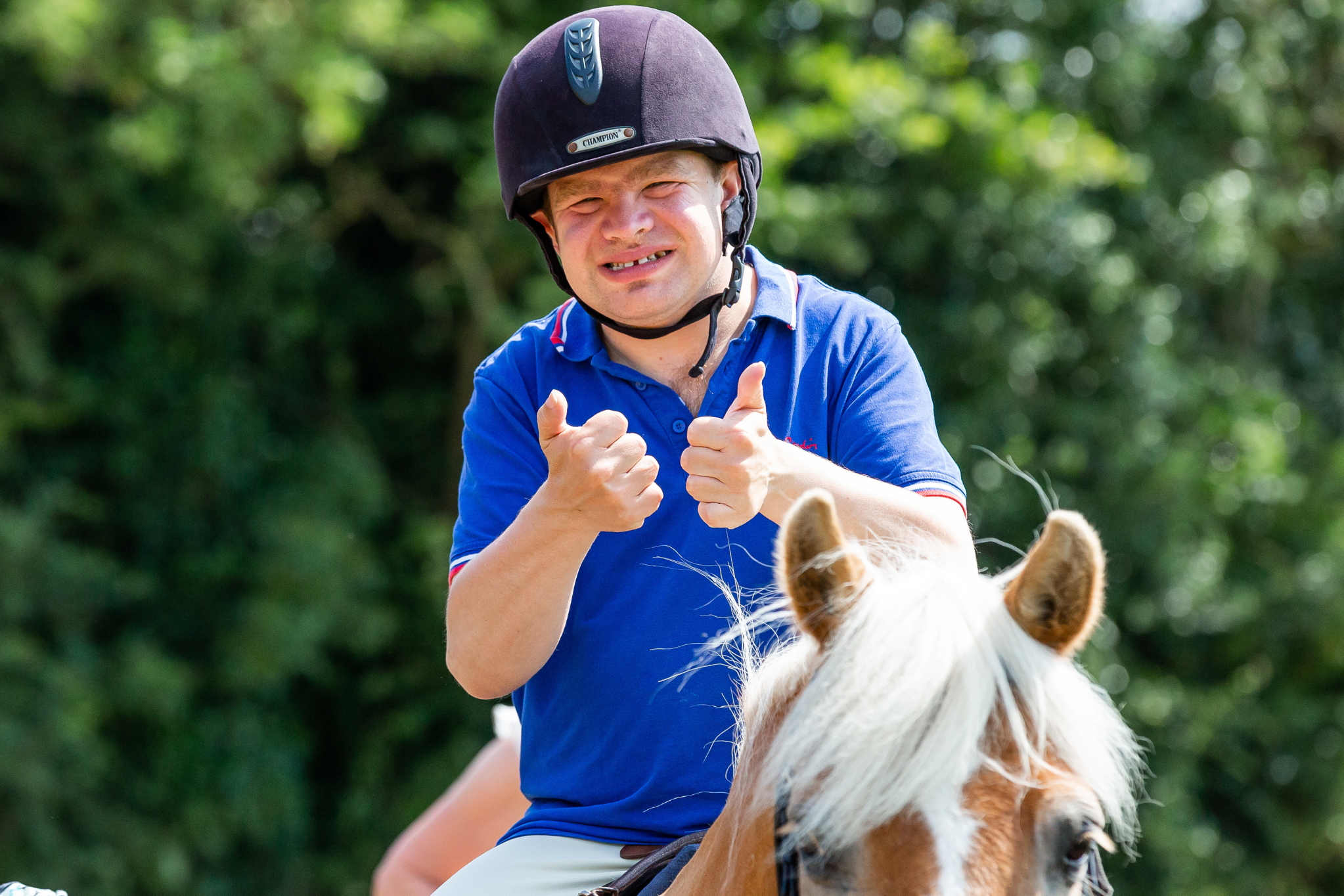 Participant on a horse with thumbs up