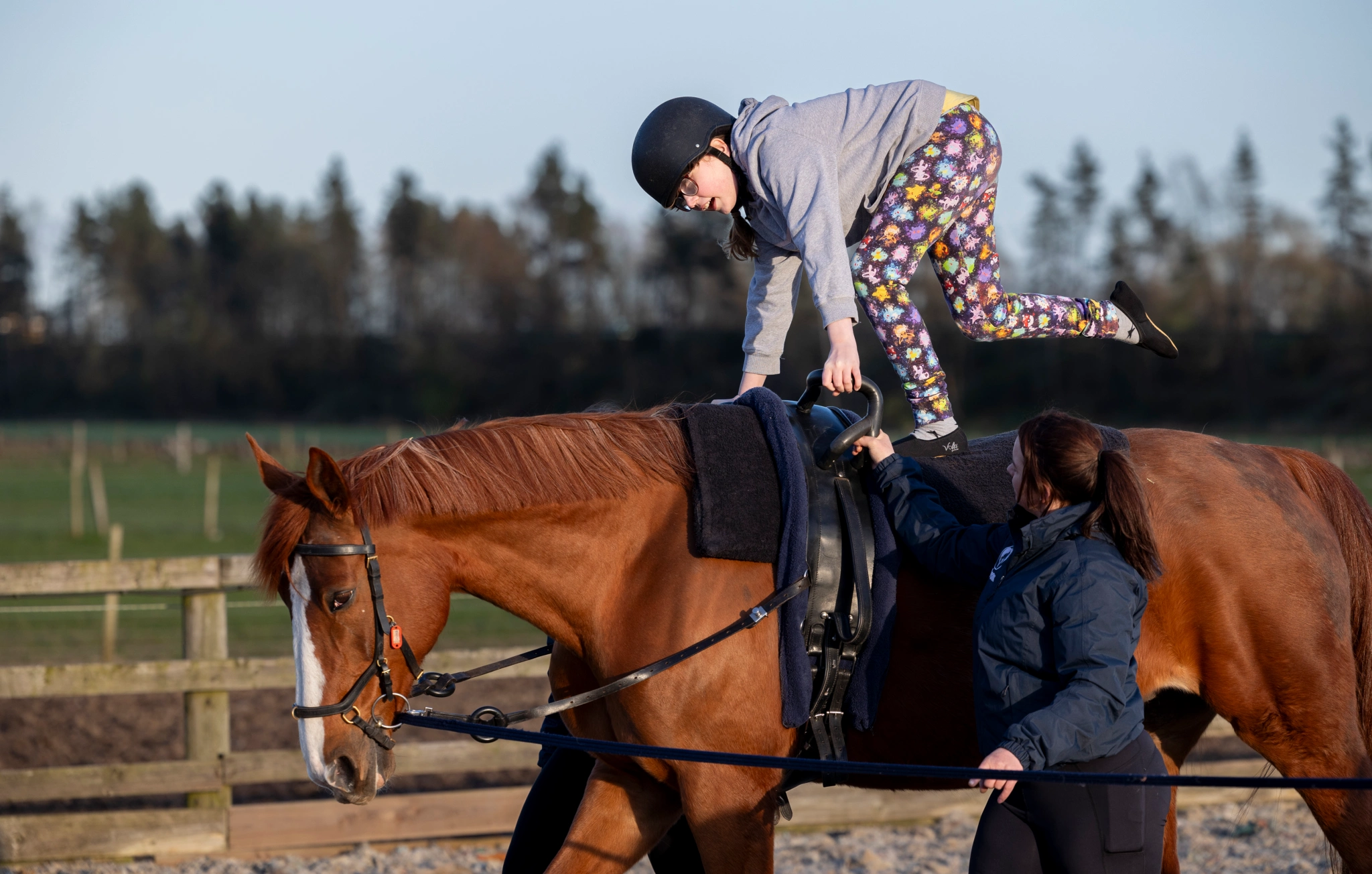 RDA participant on a chestnut horse taking part in vaulting