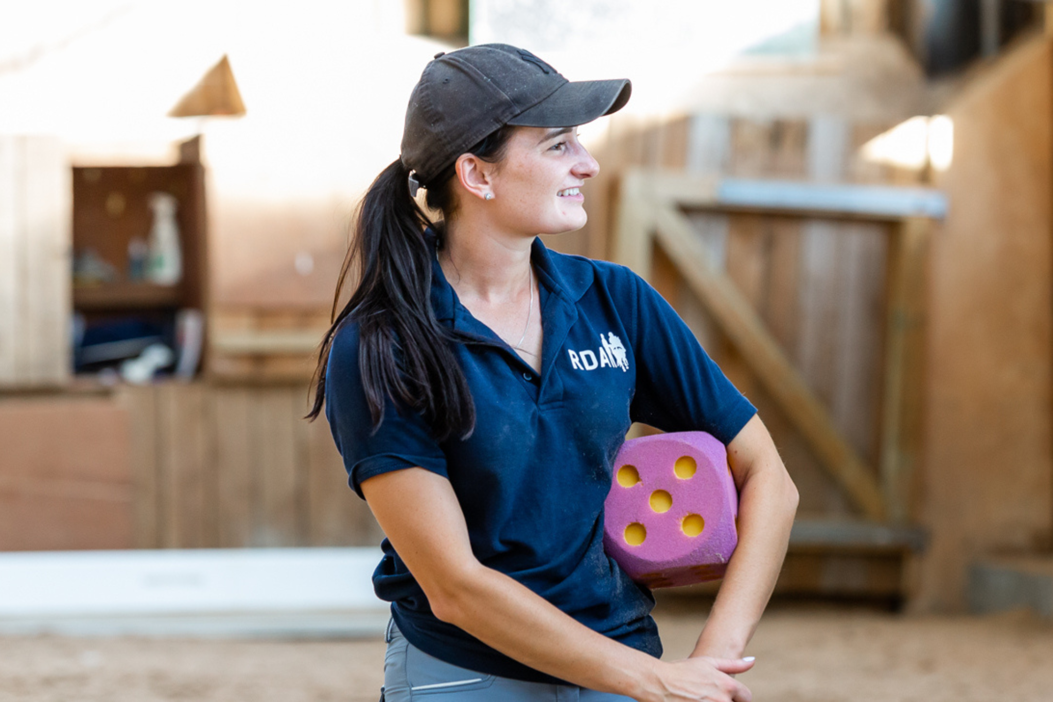 Image of an RDA coach holding a large foam dice in an RDA session